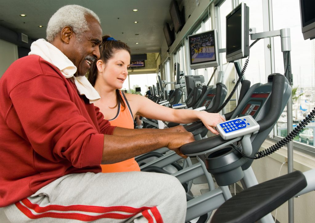 Being taught how to use equipment at the gym